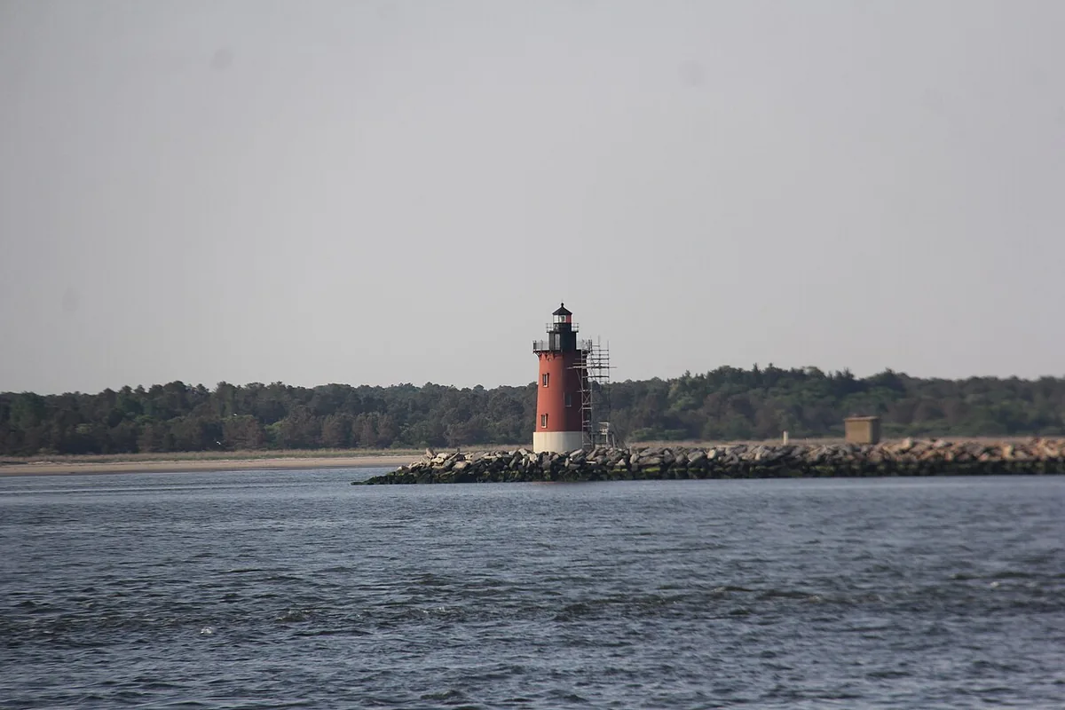 The red and white Delaware Breakwater East End Light standing on its stone breakwater off Lewes, Delaware.